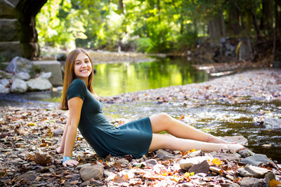 Hali Iliff posing by a creek bed in sewickley Pennsylvania for her Quaker Valley senior photos pittsburgh class of 2020 session with her mom heidi iliff.