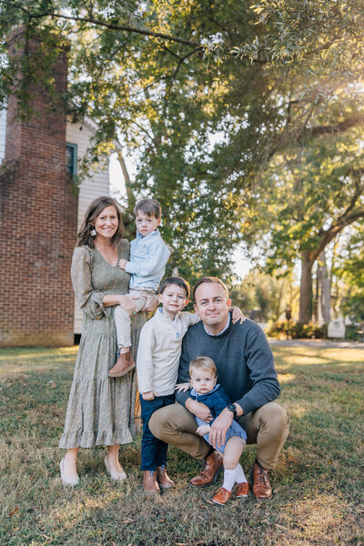 family photographer in madison al by whitney briscoe - family of five smiling at camera in mooresville alabama