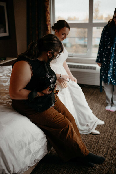 taeya sitting beside a bride showing her what to do