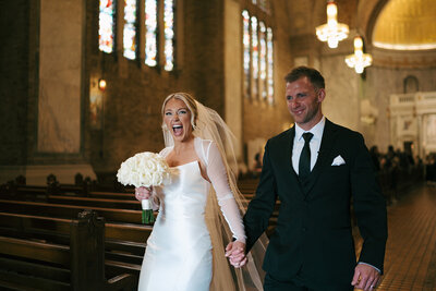 bride and groom kissing exiting the church after ceremony 