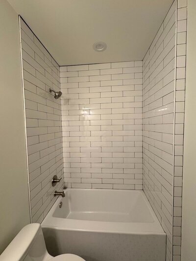bathroom with new tiles and bathtub by one of the best renovation companies in atlanta