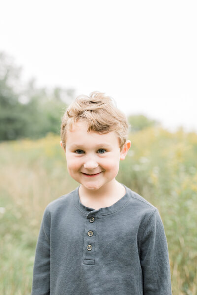 Young boy smiling in field Green Bay