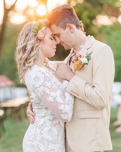 Wedding couples photoshoot  with man in purple suit coat and woman in wedding dress while wearing crown on her head