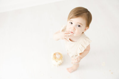 Toddler eating cake for 1st birthday photos by Northern Virginia Photographer