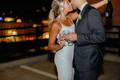 rooftop engagement photos at night with champagne