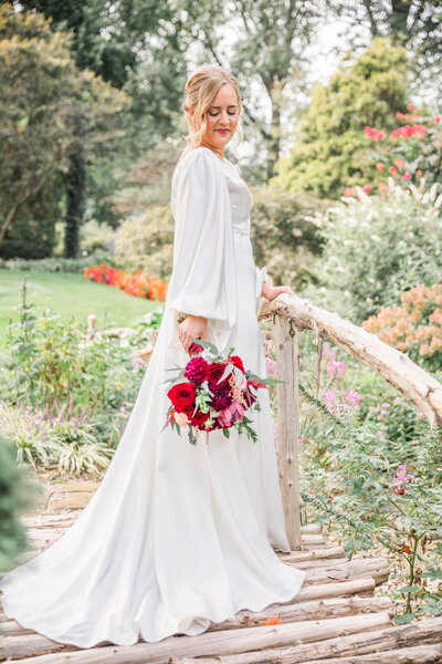 bride holding bouquet for portraits on the bridge
