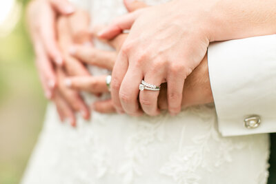 Closeup of a white couple's hands, showing their rings