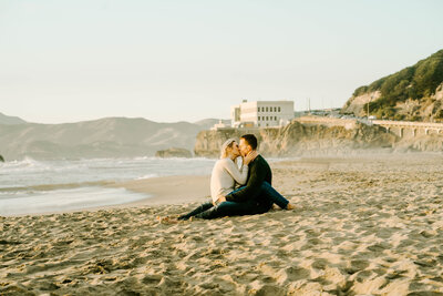 couple sitting on the beach in San Francisco