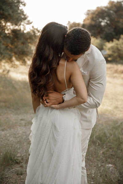 groom hugs bride after wedding in san diego