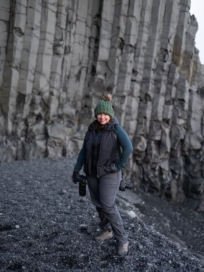 Kristen Vann standing on a black sand beach in Iceland. 