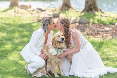 Bride and Bride kissing with their dog