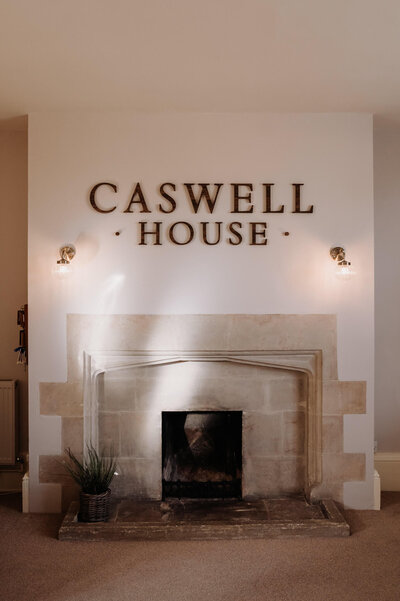 Cosy fireplace feature in the entrance hall at Caswell House