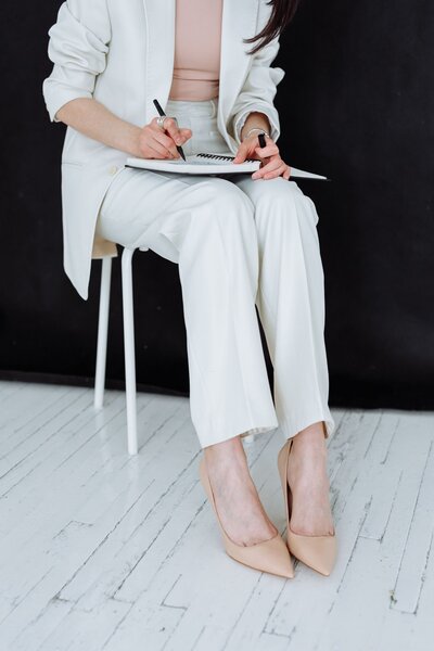 Woman in Suit Writing in Planner