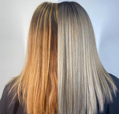 Before and after image of client with hair that has been transformed from a copper and warm blonde to an ashy and platinum blonde.