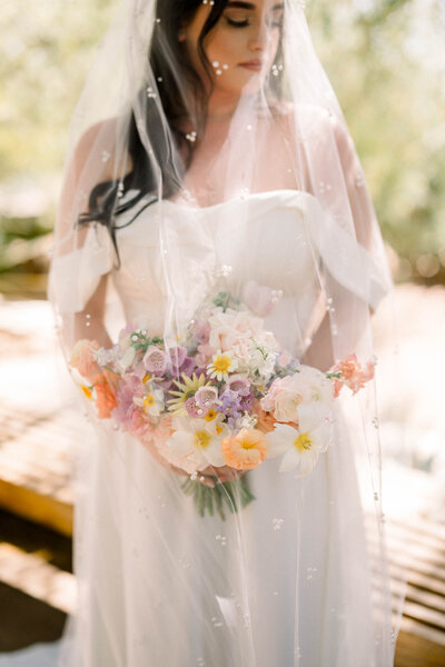 beautiful bride at el chorro wedding holding luxury bouquet from snapdragon bloom bar