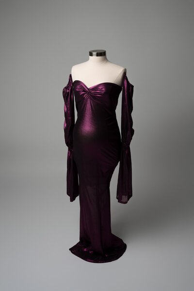 Structured purple dress with long sleeves and sweetheart neckline styled on mannequin for studio shoot