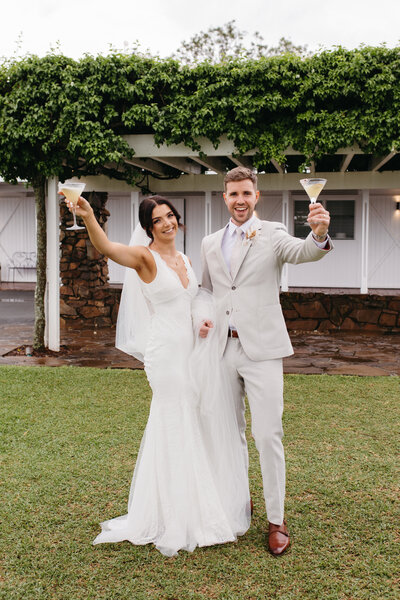 bride & groom at Fins Plantation house cheers - brunette upstyle, soft glam makeup