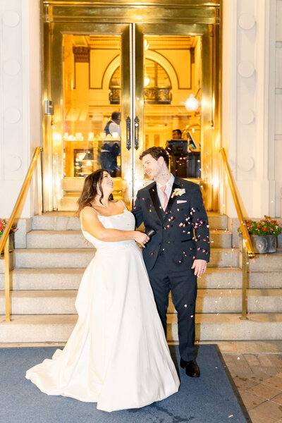 Bride and groom happily walking down the stairs