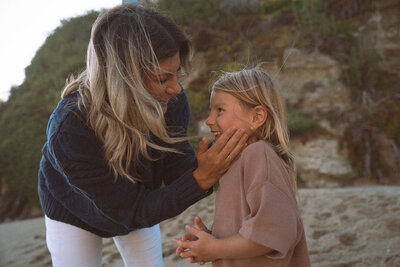 Mother and daughter sharing a candid moment at Table Rock Beach in Laguna Beach.