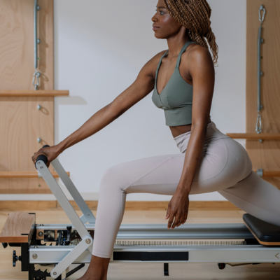 Another woman working out on a Pilates reformer, representing dynamic reformer exercises at Jaz Pilates, highlighted through Muse Studio’s content creation expertise