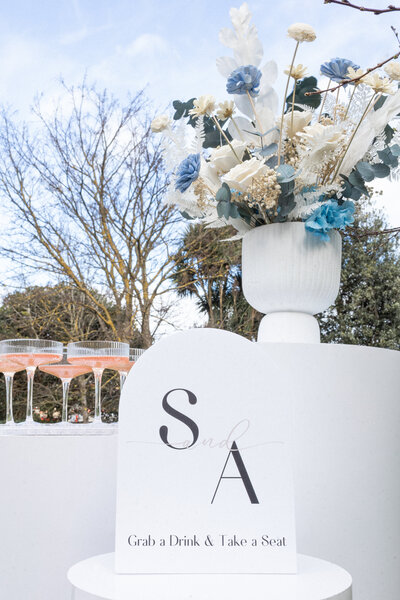 Personalised signage and floral arrangement for wedding reception