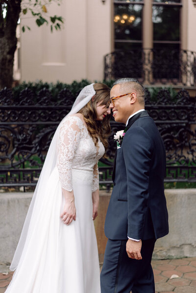 Casey and Roberto smiling together at their Richmond wedding, captured in soft editorial light and nostalgic tones.