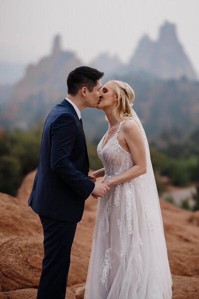 Wedding and Elopement Photography, bride and groom kiss during Garden of the Gods elopement.