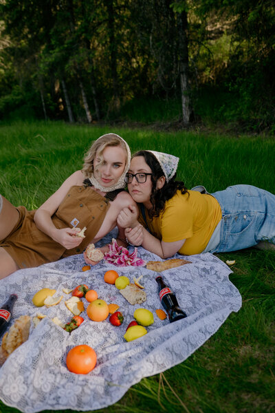 A candid moment of photographers enjoying a whimsical outdoor picnic, showcasing the playful and intimate side of Seattle wedding photography.