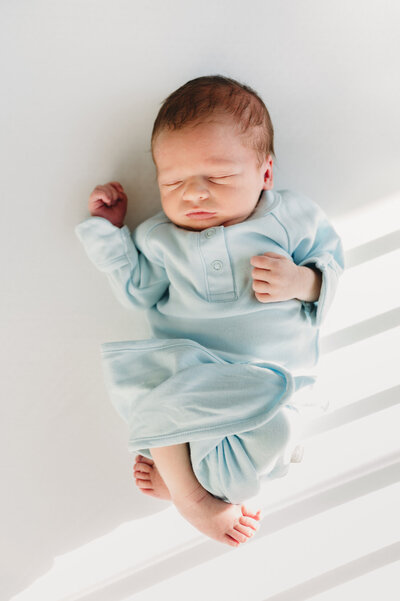 newborn baby in a blue gown