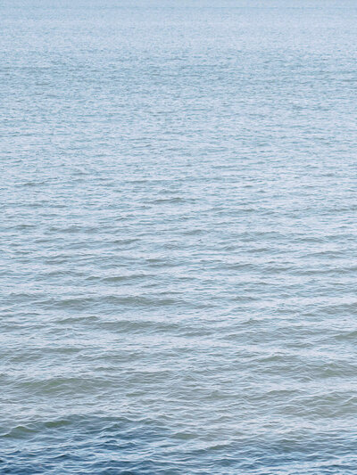 Peaceful rippling water captured near a Williamsburg, VA waterfront wedding.
