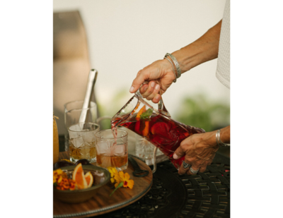 woman pouring a pitcher of red sangria