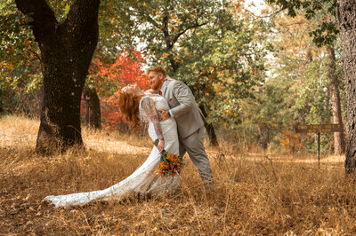 bride and groom in fall forest