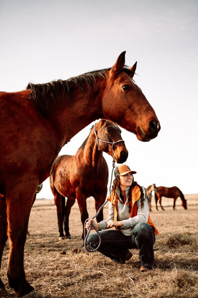 ranch wife with her horses in the field