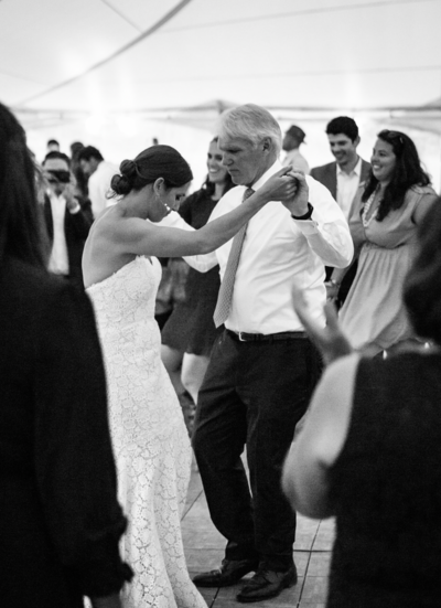 A bride dancing with her father on her wedding night.