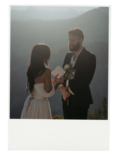 bride reads vows to groom while groom smiles at bride in Yosemite the photo is in a polaroid frame