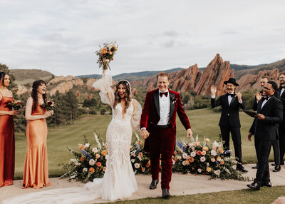 Bride and groom cheering at the alter in Colorado wedding