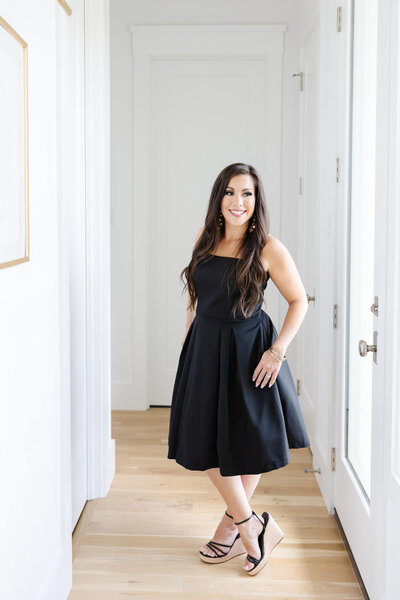 Monica Louie in a black dress looking sideways