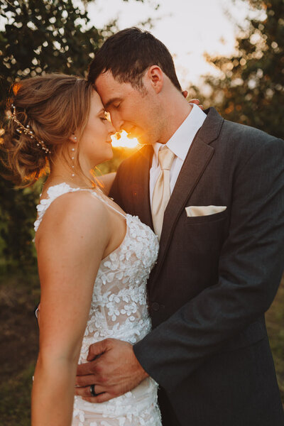 Bride and groom embracing with fall colors