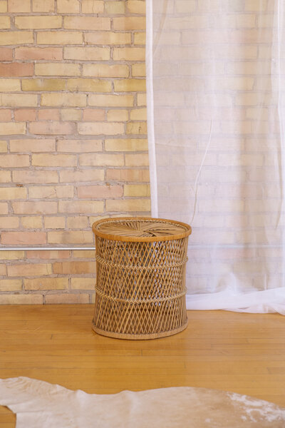 A small round rattan end table.