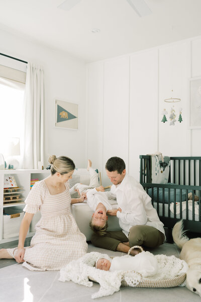 Family and dog admiring newborn baby in orange county lifestyle newborn session