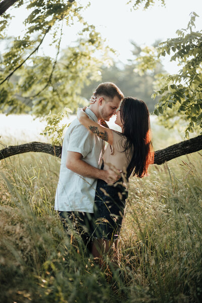 couple standing under tree