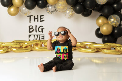 little boy in sunglasses for tulsa cake smash session