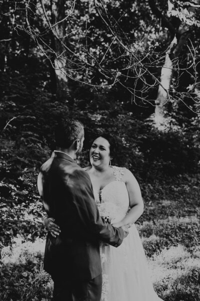 Bride and groom smile for wedding portraits at Roanoke Park wedding