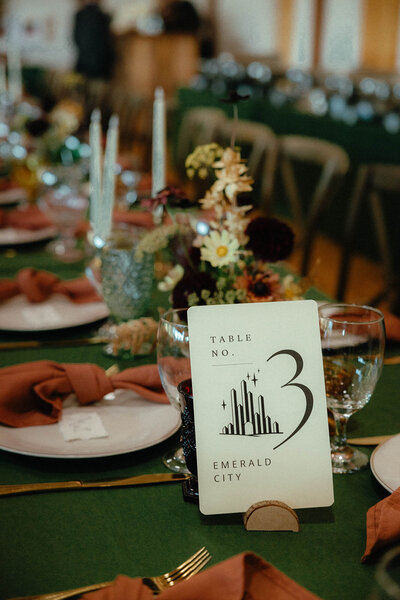 Table number card and places ettings at a wedding, representing the evenst and planning services of Birdie June.