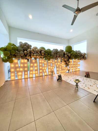 Romantic balloon decor setup with 3 ft marquee letters for a marriage proposal by Loononna, LLC in Orlando, FL.