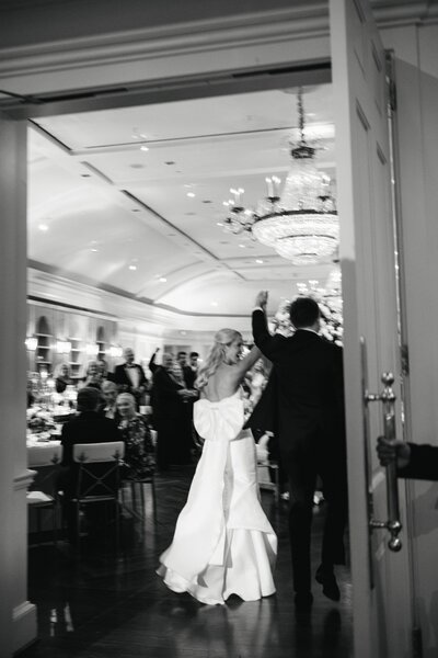 bride and groom entering their wedding reception