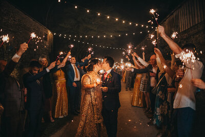 couple kiss during sparkler exit