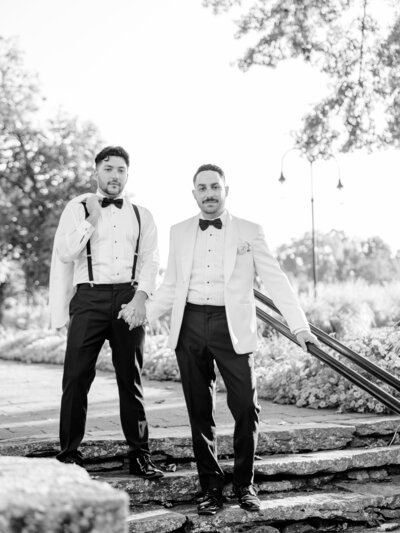 groom and groom posing on stairs looking editorial