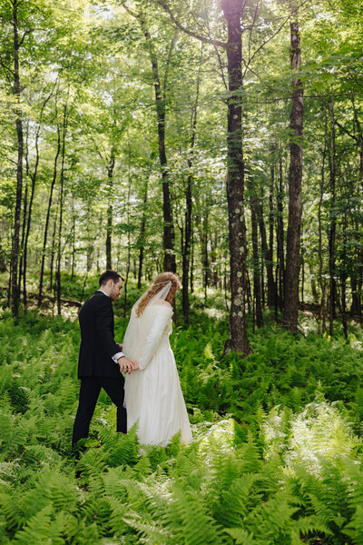Bride with father walking down in aisle at forest wedding in Finger Lakes, New York