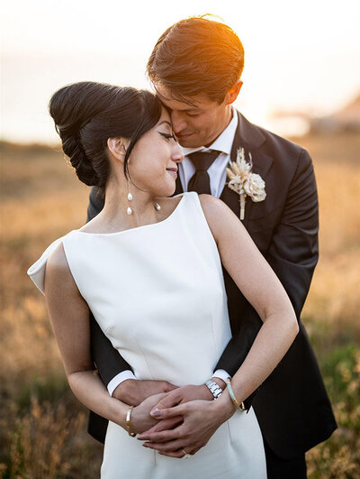 Portrait of a bride and groom with a sunflare at Timber Cove Resort by San Francisco Wedding Photographer Duy Ho